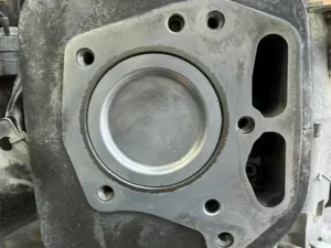 Cylinder head rebuild for a concrete equipment engine showing the piston and cylinder after disassembly and inspection.