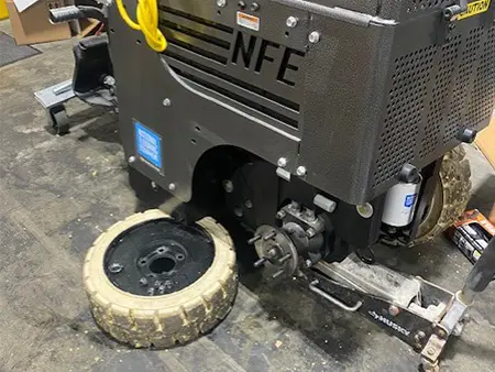 Ride-on floor scraper undergoing repair and maintenance service at Loyd's Equipment Repair